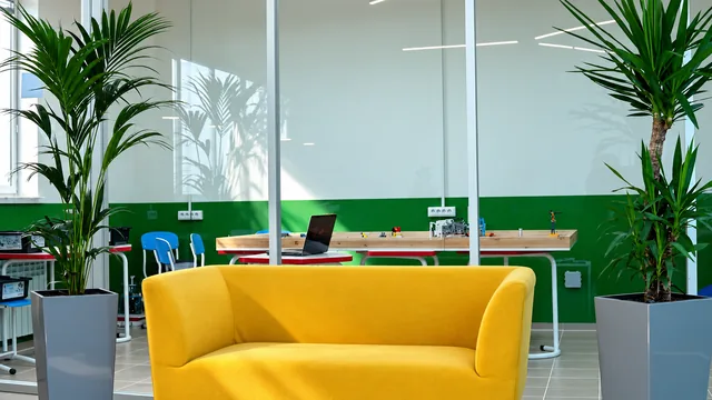 Completed interior: Yellow sofa and indoor plants beside the glass partition in the lounge