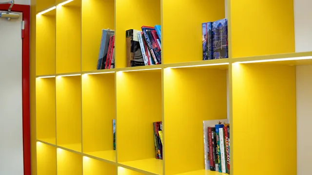 Completed interior: Built-in yellow shelving for books and learning materials